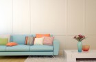 Blue sofa with colorful pillows and a white coffee table