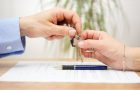real estate agent gives house keys to his client after signing contract